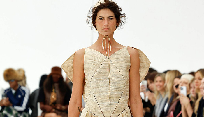 Amy Lawrance 2025 Resort Cruise Pre-Spring Womens Runway Collection - Australian Fashion Week - Old World Mid-Century Amish Sci-Fi Headwear Sailor Nurse Cap Strings Cutout Slashed Mesh Grid Lattice Pinafore Dress V-Neck Geometric Lines Circle Box Skirt Linen Accordion Pleats Frayed Cap Sleeve Capelet Noodle Strap Octahedron Mini Bag Lace Up Socks