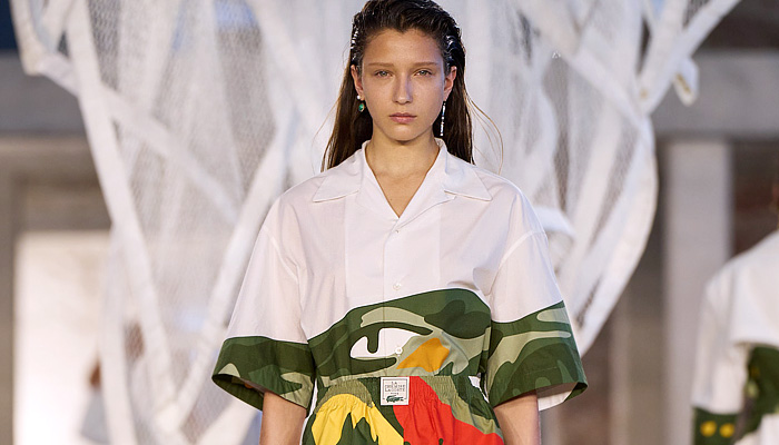 Lacoste 2025 Spring Summer Womens Runway Collection - Paris Fashion Week PFW - Tennis to the Sea Side - Embroidery Patches Sheer Shirt Loungewear Knit Vest Mesh Shift Dress Cutout Waist Diamond Logo Giant Crocodile Wool Blazer Jacket Outerwear Parka Coat Windbreaker Nylon Shorts Miniskirt Pleats Onesie Coveralls Jumpsuit Caftan Kaftan Halterneck Handbag Fisherman Sandals Wrapped Shoes