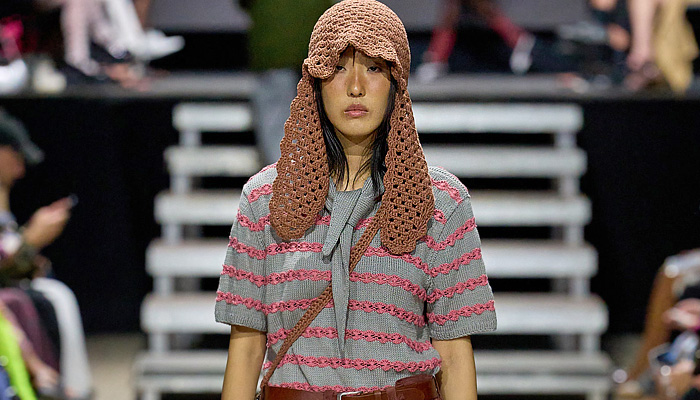 Rolf Ekroth 2025 Spring Summer Womens Runway Collection - Copenhagen Fashion Week Denmark CPHFW København - Lavatanssit - Patchwork Blazer Jacket Check Herringbone Plaid Stripes Shorts Culottes Hood Anorak Windbreaker Camouflage Crochet Mesh Ear Flaps Knit Cap Blouse Corduroy Baggy Loose Knee Panels Outdoor Pants Bomber Jacket Artwork Flowers Floral Plants Scarf Sling Pack Trompe L'oeil Dandelions Denim Jeans Sneakers