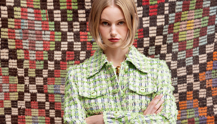 St. John 2025 Spring Summer Womens Lookbook - New York Fashion Week NYFW - 1960s Sixties Head Scarf Wrap Cross Halterneck Crop Top Midriff Blouse Long Sleeve Bandanna Top Strapless Accordion Pleats Skirt Flowers Floral Geometric Robe Kimono Lace Embroidery Camisole Slip Dress Tweed Knit Pantsuit Blazer Jacket Brocade Embroidery Decorative Art Sparkle Sequins Bedazzled Shorts Miniskirt Denim Jeans Wide Leg Flare Palazzo Pants